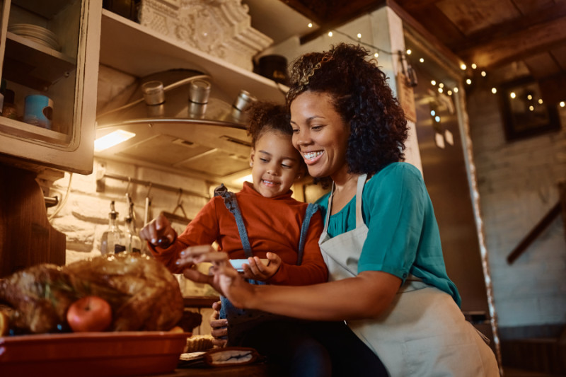 Cooking fall recipes - mom and daughter